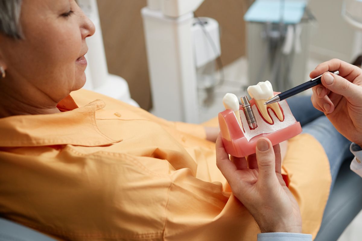 Dentist explaining dental implant options to an older adult
